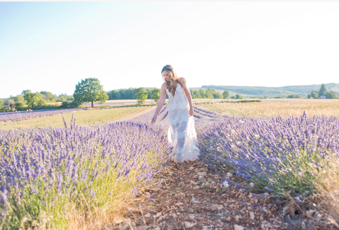 Gina DeVee walking through lavender fields in Provence at golden hour